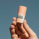 Little Urchin vanilla coconut lip balm held in hand