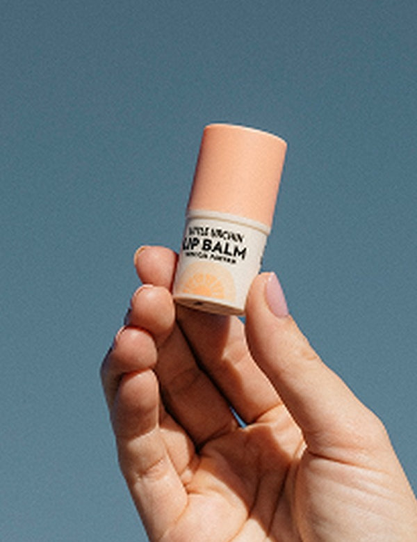 Little Urchin vanilla coconut lip balm held in hand