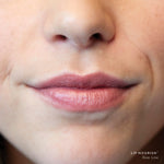 Close-up of lips wearing Rose Lime Lip Nourish, showing a sheer warm nude-rose colour with a subtle glossy finish.