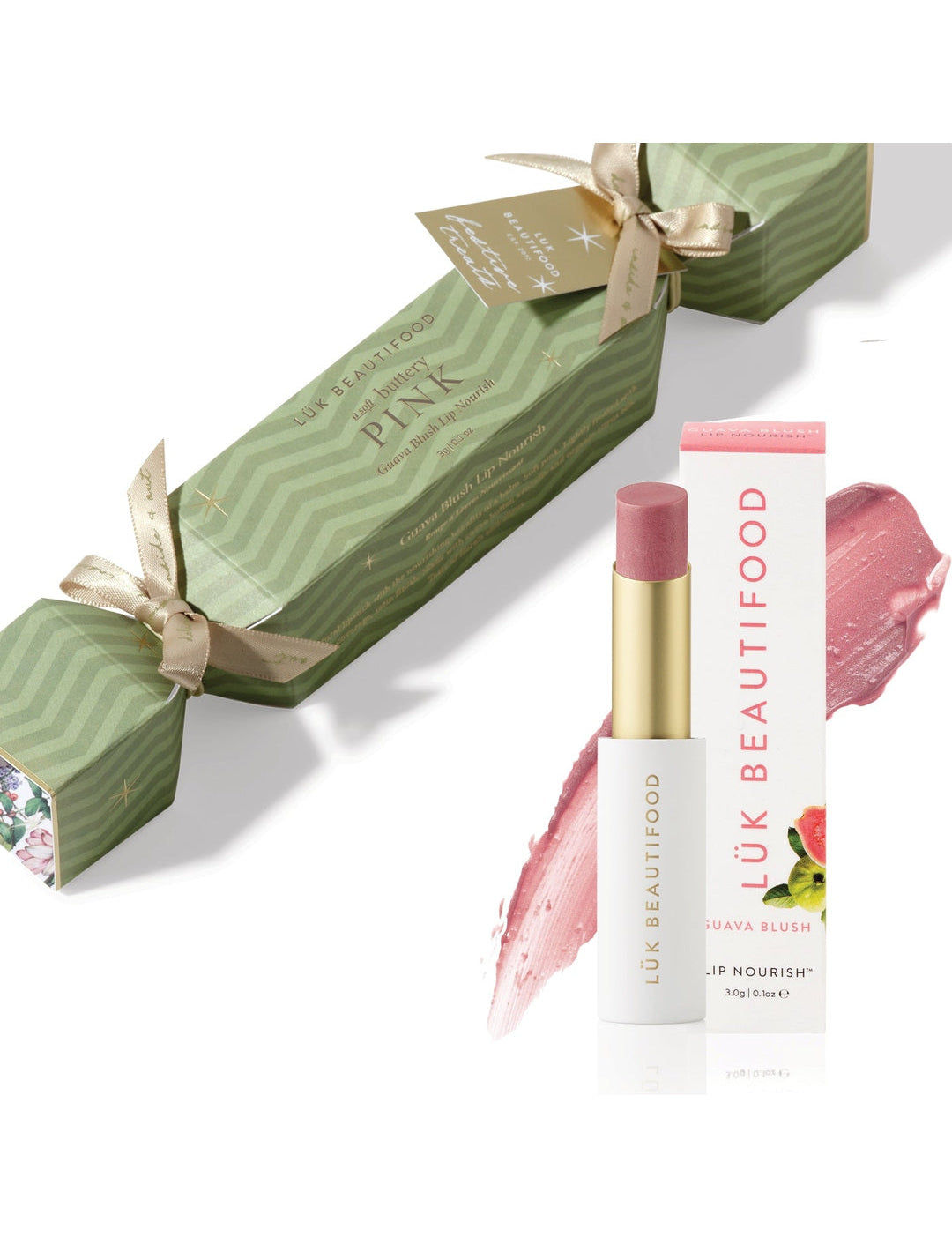 Soft Buttery Pinks Bon Bon: light green Christmas cracker with gold ribbons, Guava Blush Lip Nourish lipstick, its white carton and a soft pink colour smear.