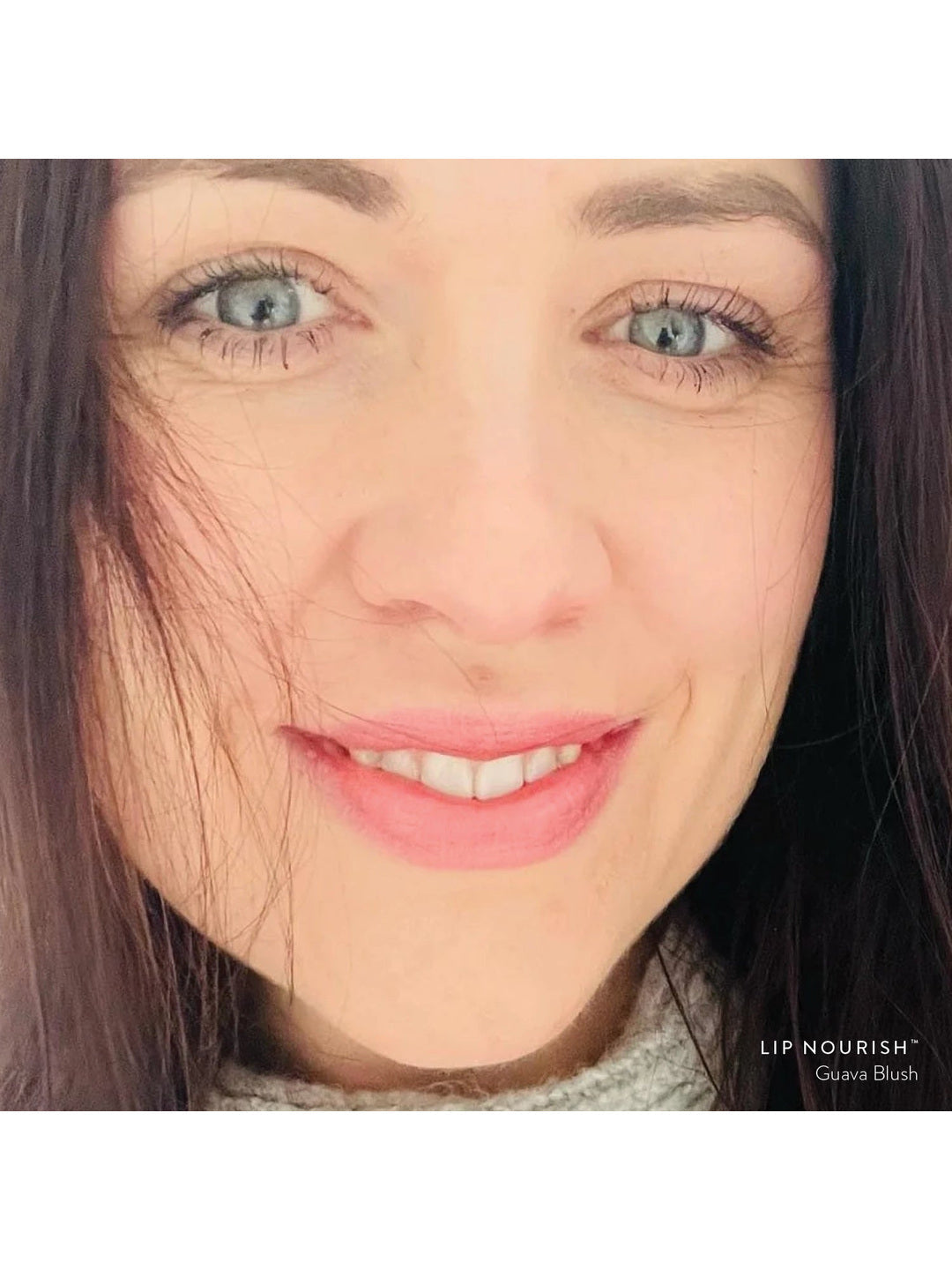 Model wearing Guava Blush Lip Nourish, showing a soft pink lip colour in a close-up portrait.