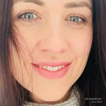 Model wearing Guava Blush Lip Nourish, showing a soft pink lip colour in a close-up portrait.