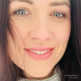 Model wearing Guava Blush Lip Nourish, showing a soft pink lip colour in a close-up portrait.