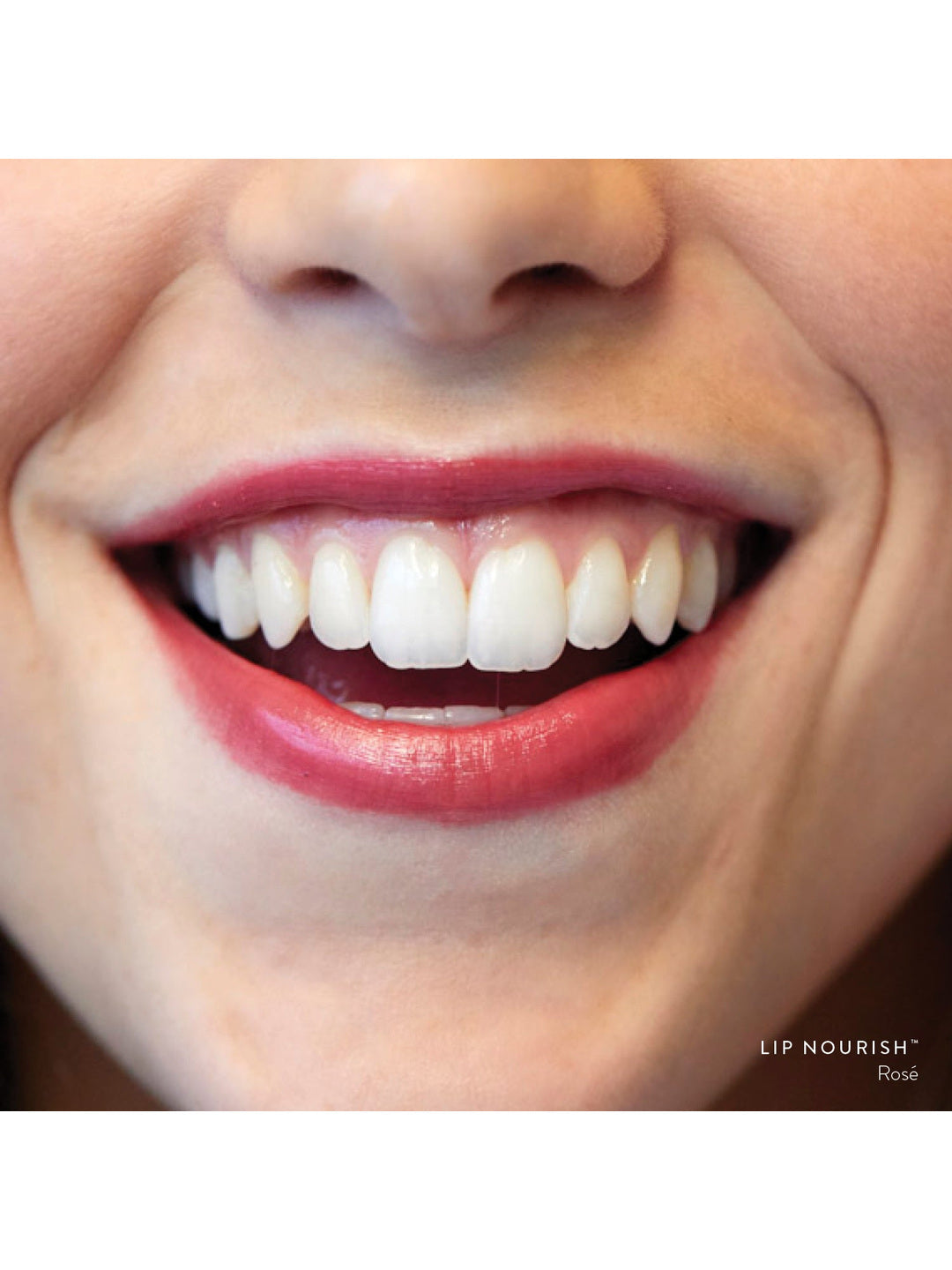Close-up of a smile wearing Rosé Lip Nourish, showing a sheer wine-red lip colour with a glossy finish.