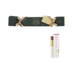 Luk Beautifood Bon Bon Lip Nourish Cracker in The Perfect Nude: a dark green cracker with gold ribbons and tag, shown with Rose Lime lipstick and its carton.