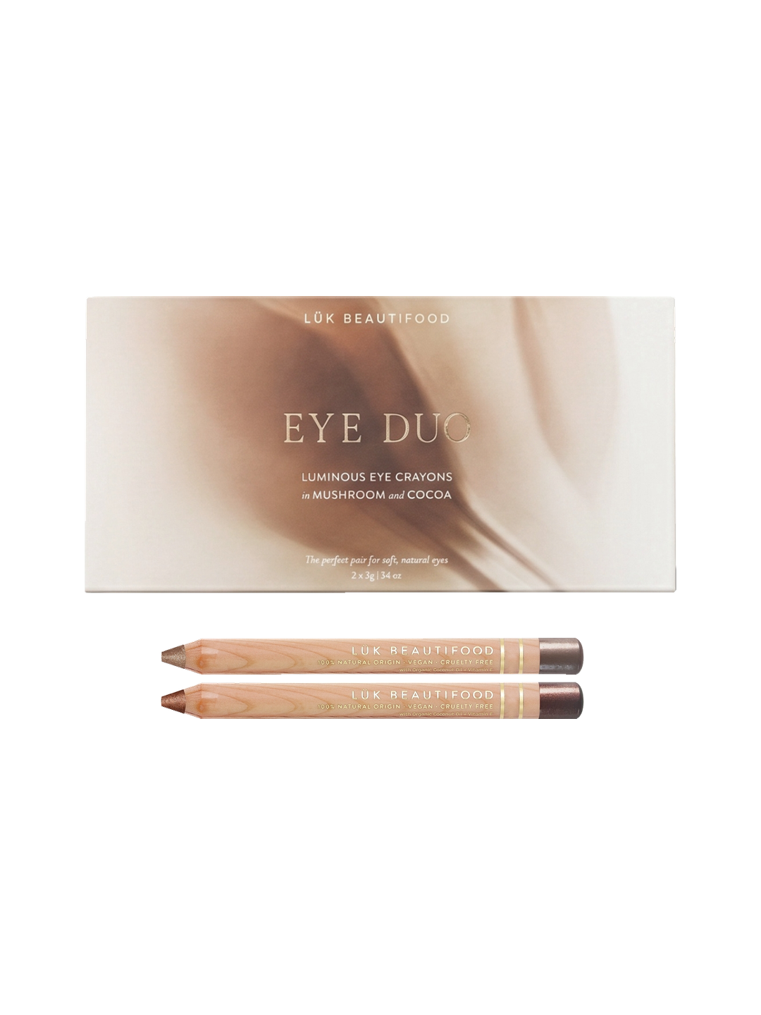 Luk Beautifood Warm Cocoa Luminous Eye Crayon Duo on white: gift box above two wooden eye pencils in rosy-taupe Mushroom and bronze-brown Cocoa.