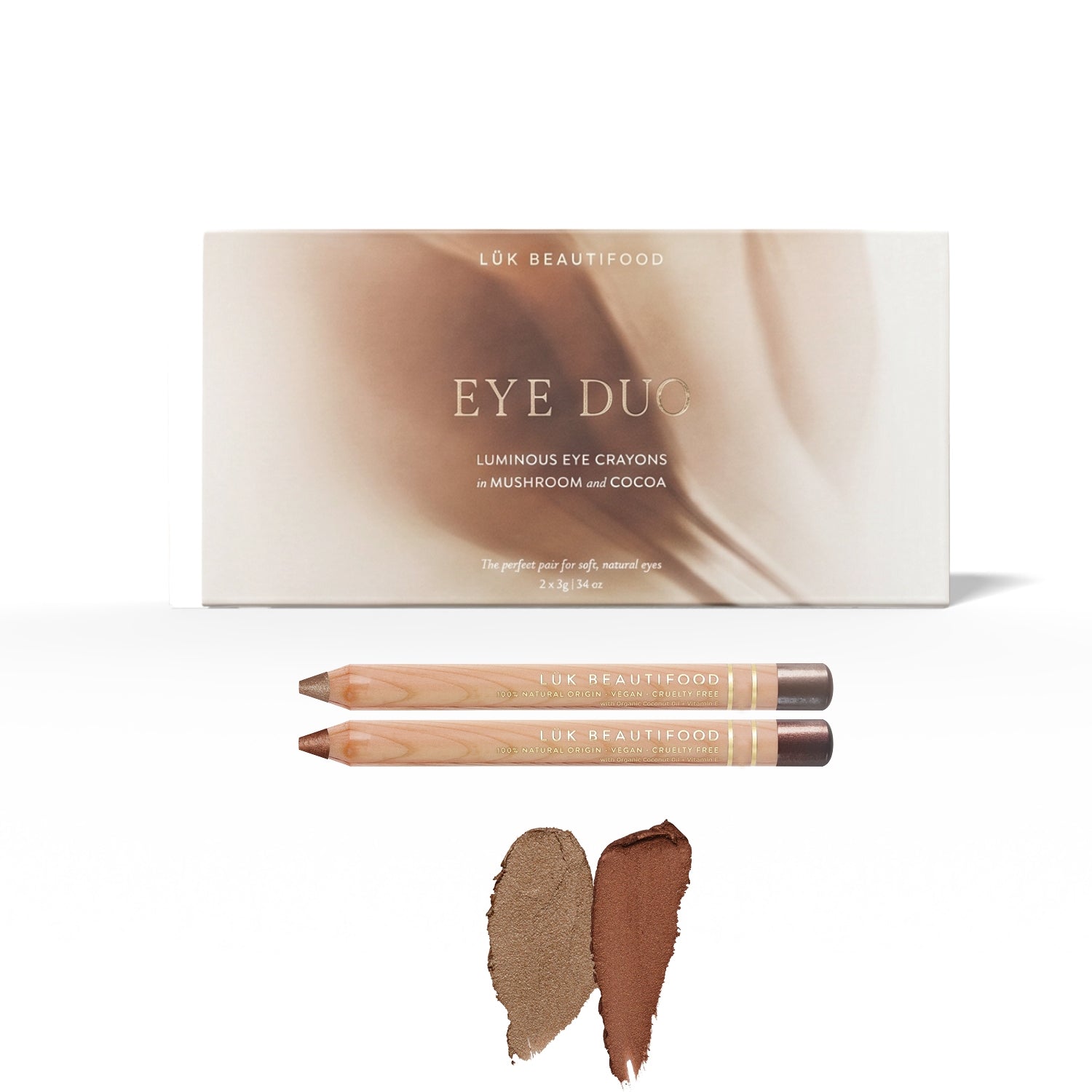 Warm Cocoa Luminous Eye Crayon Duo: gift box, Mushroom and Cocoa wooden crayons, and matching rosy-taupe and bronze-brown swatches.