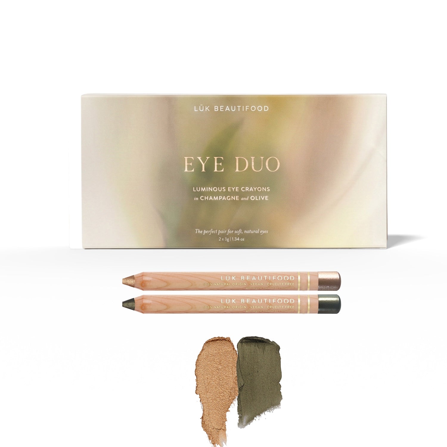 Golden Olive Luminous Eye Crayon Duo: gift box, Champagne and Olive wooden crayons, and matching warm gold and dark khaki-green swatches.