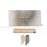 Soft Smoke Luminous Eye Crayon Duo: gift box, Pearl and Smoke wooden crayons, and matching pale vanilla-gold and deep silver-grey swatches.