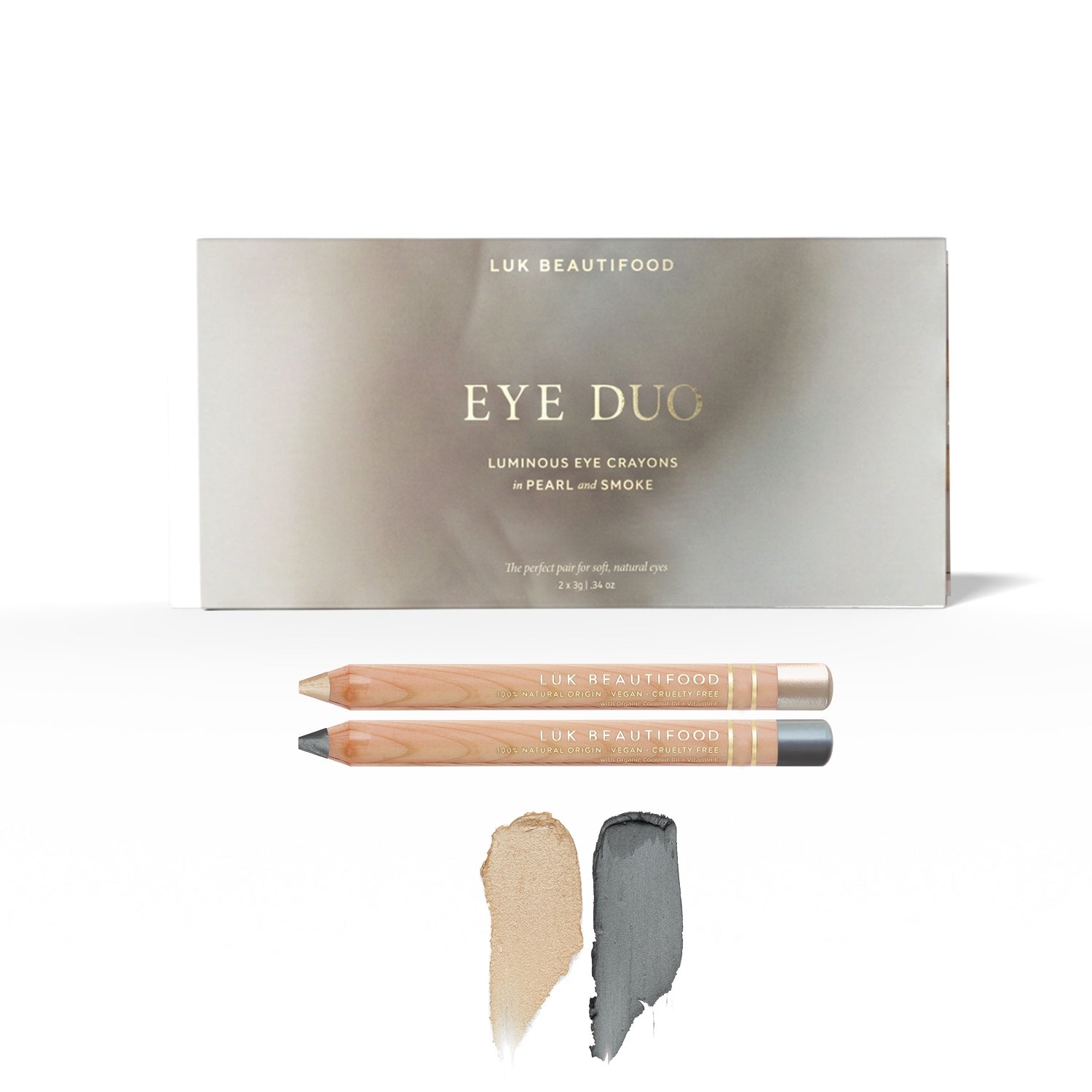 Soft Smoke Luminous Eye Crayon Duo: gift box, Pearl and Smoke wooden crayons, and matching pale vanilla-gold and deep silver-grey swatches.