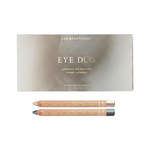 Luk Beautifood Soft Smoke Luminous Eye Crayon Duo on white: gift box above two wooden eye pencils in pale vanilla-gold Pearl and deep silver-grey Smoke.