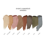 Luminous Eye Crayon colour chart: eight creamy shimmer swatches labelled Pearl, Champagne, Sorbet, Mushroom, Cocoa, Truffle, Olive and Smoke, arranged from light gold to deep grey.
