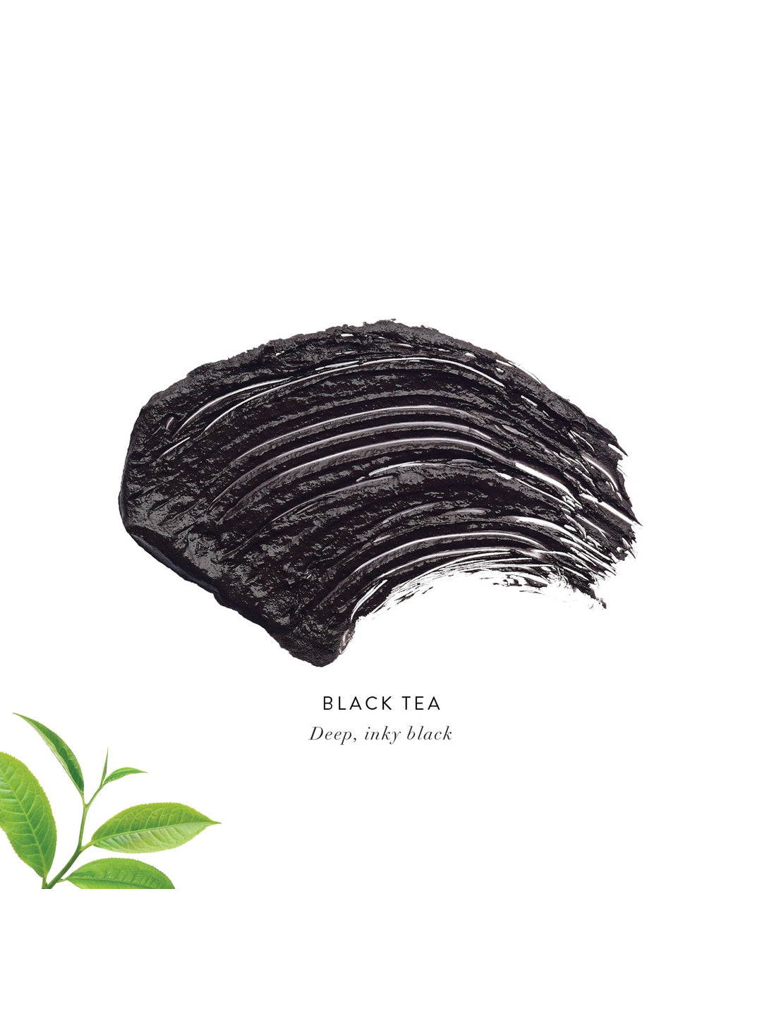 Black Tea Lash Nourish Mascara swatch showing a thick, textured stroke of deep inky black mascara, with green tea leaves in the corner.