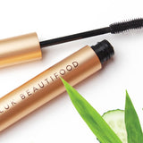 Open Luk Beautifood Lash Nourish Mascara styled with cucumber and botanical leaves