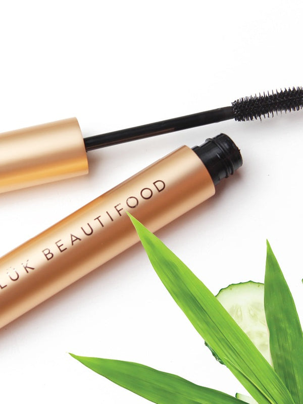 Open Luk Beautifood Lash Nourish Mascara styled with cucumber and botanical leaves