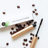 Luk Beautifood Lash Nourish Mascara styled with coffee beans on a marble surface