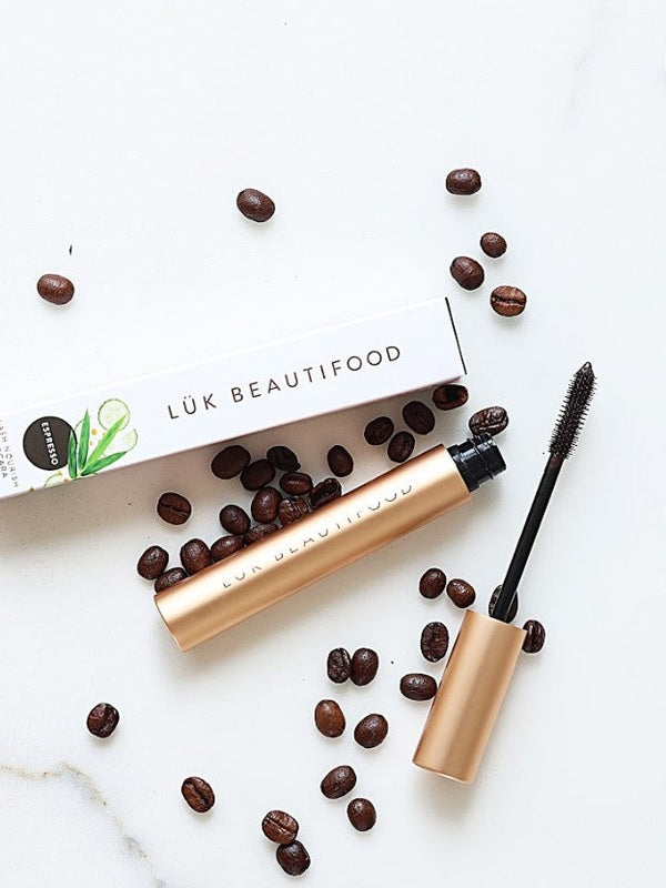 Luk Beautifood Lash Nourish Mascara styled with coffee beans on a marble surface