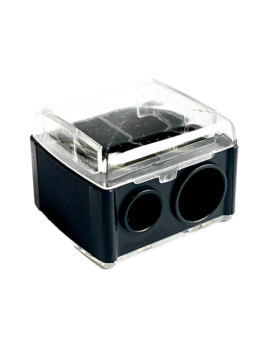 Black rectangular Luk Beautifood lip-crayon sharpener with a clear lid and two circular sharpening holes of different sizes.