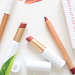 Luk Beautifood Lip Nourish lipsticks and Lipstick Crayons styled with botanical leaves and colour swatches