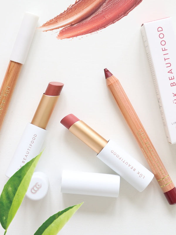 Luk Beautifood Lip Nourish lipsticks and Lipstick Crayons styled with botanical leaves and colour swatches