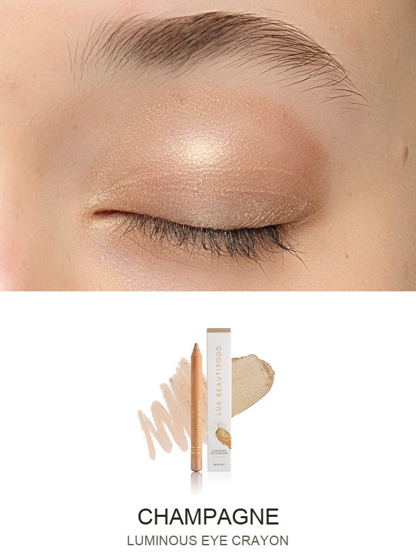 Luk Beautifood Luminous Eye Crayon in Champagne: close-up of the shade on an eyelid above the matching crayon, carton and pigment swatch. Champagne is labelled at the bottom.