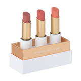 Luk Beautifood Lip Nourish Trio in Perfect Nudes: three uncapped lipsticks in Tea Rose, Nude Pink and Peach Melon, standing in an open white and gold presentation box.