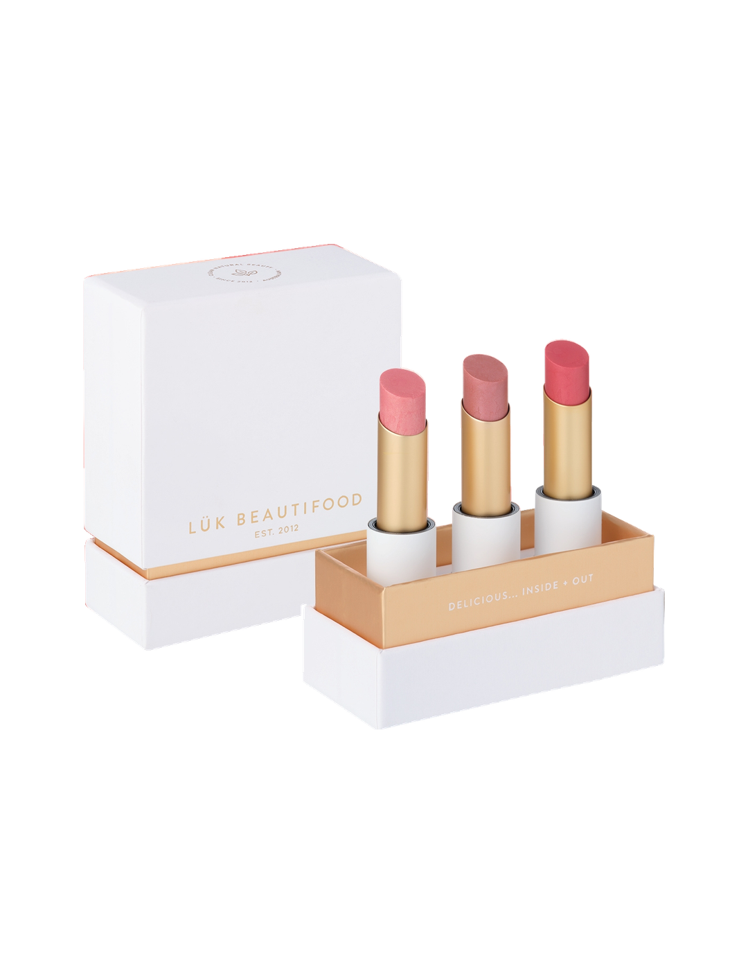 Luk Beautifood Buttery Pinks Lip Nourish Trio on white: Guava Blush, Pink Juniper and Ruby Grapefruit lipsticks standing in an open white and gold presentation box beside its lid.