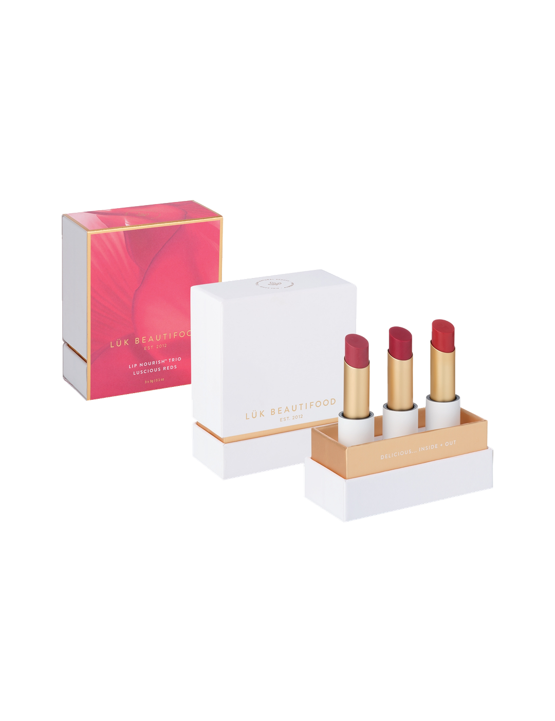 Luk Beautifood Luscious Reds Lip Nourish Trio on white: Rosé, Cherry Plum and Cranberry Citrus lipsticks in an open white and gold gift box beside the lid and pink-and-gold sleeve.
