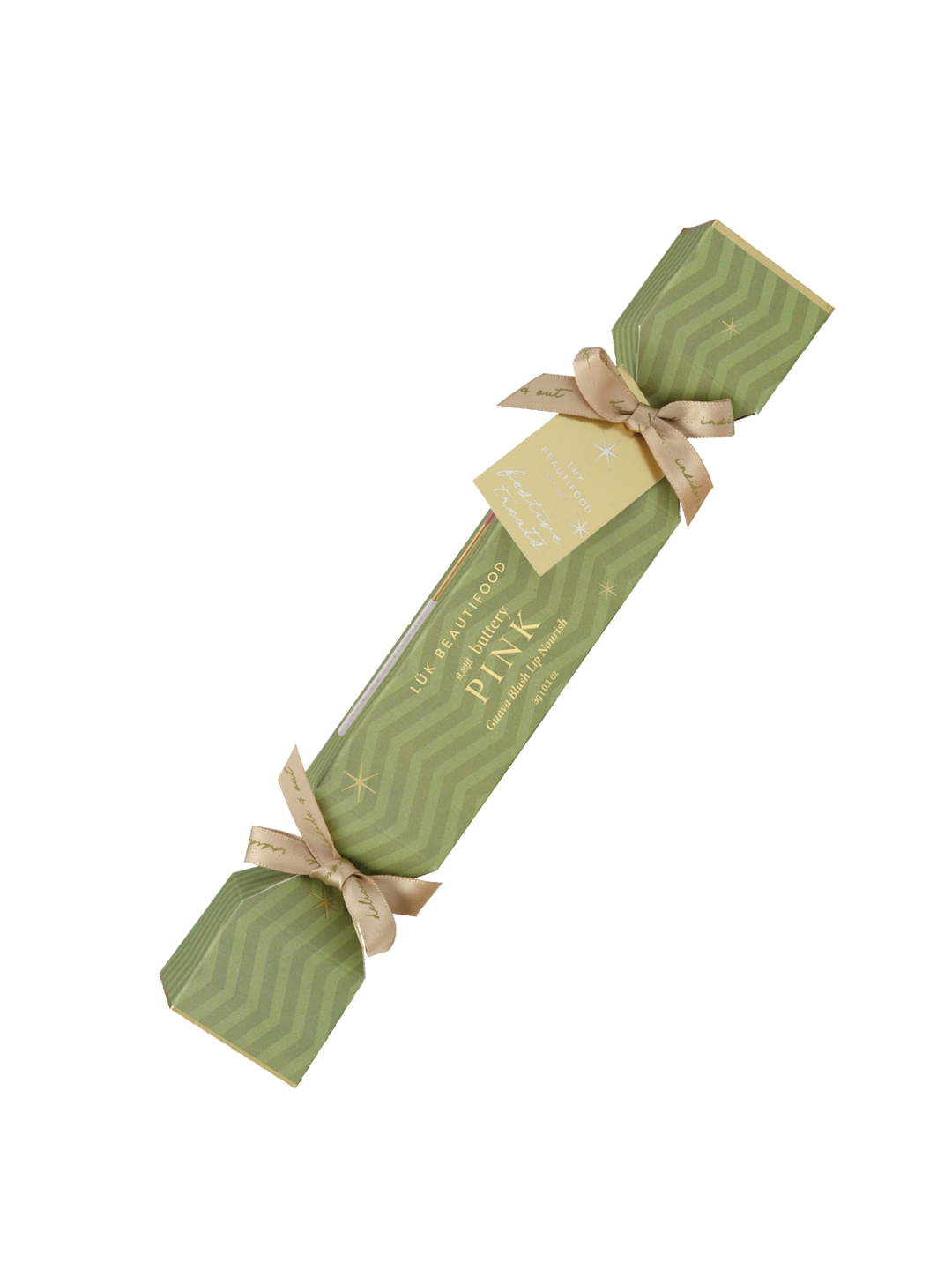 Single Luk Beautifood Guava Blush lip bonbon, a light green Christmas cracker with gold ribbon bows and a gift tag, shown diagonally on white. The packaging reads Soft Buttery Pink.