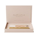 Luk Beautifood Feast for your Eyes Black Tea and Pearl gift set in one open cream gift box, with the lid raised above the gold mascara tube and pale eye crayon.