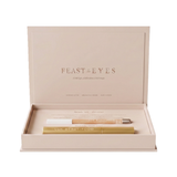 Luk Beautifood Feast for your Eyes Black Tea and Pearl gift set in one open cream gift box, with the lid raised above the gold mascara tube and pale eye crayon.