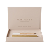 Luk Beautifood Feast for your Eyes Espresso and Champagne gift set in one open cream gift box, with the lid raised above the gold mascara tube and eye crayon.
