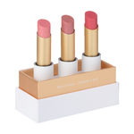 Luk Beautifood Lip Nourish Trio Buttery Pinks, with three uncapped pink lipsticks standing in a white presentation base with gold trim on a white background.