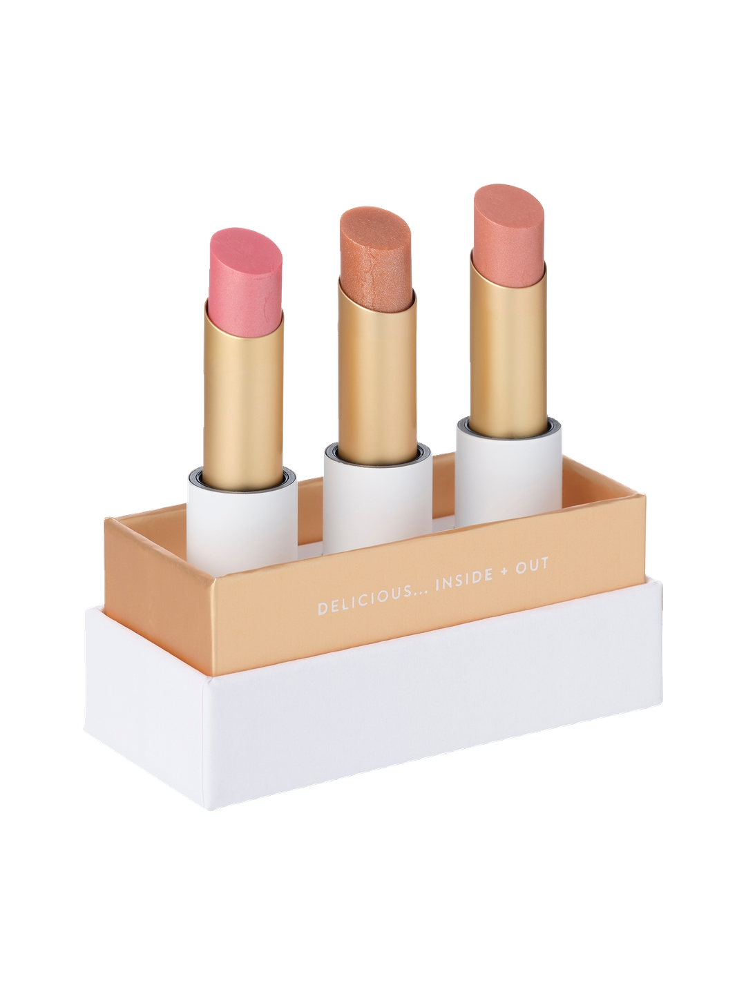 Luk Beautifood Lip Nourish Trio Sheer Delight, with three uncapped pink, bronze and nude shimmer lipsticks standing in a white presentation base with gold trim.