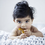 Baby using a Natural Rubber Fish Teether