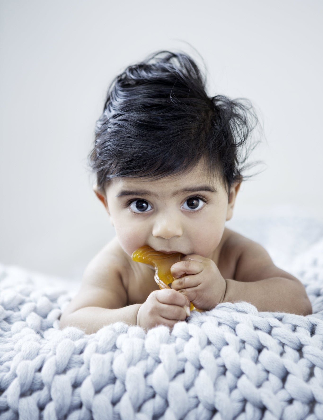 Baby using a Natural Rubber Fish Teether