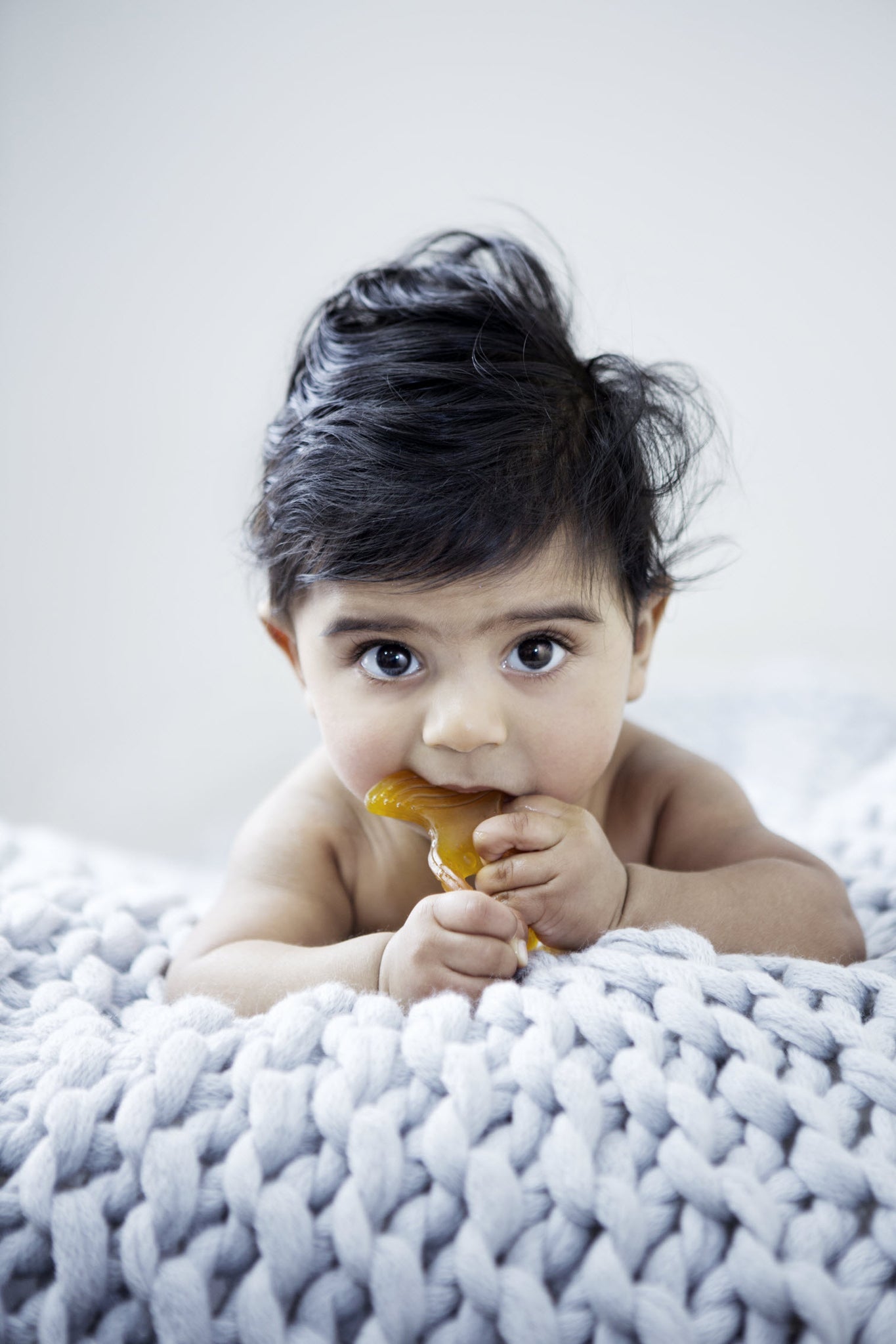 Baby using a Natural Rubber Fish Teether