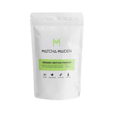A white resealable pouch labeled Matcha Maiden Matcha Green Tea Powder 100% Pure Stone Ground features a green label noting it's organic, vegan-friendly, gluten-free, and made from 100% pure Japanese green tea.