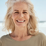 Smiling mature woman at the beach in official Melrose FutureLab Bone Matrix lifestyle imagery