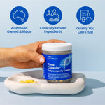 Hand holding Melrose FutureLab Time Capsule on a styled blue surface with capsules