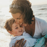 Mother and child at the beach in official Melrose FutureLab Vitamin C Liposomal lifestyle imagery