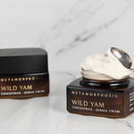 Metamorphosis Wild Yam Concentrate Dermal Cream jar, lid and small silver spoon arranged on pale marble.