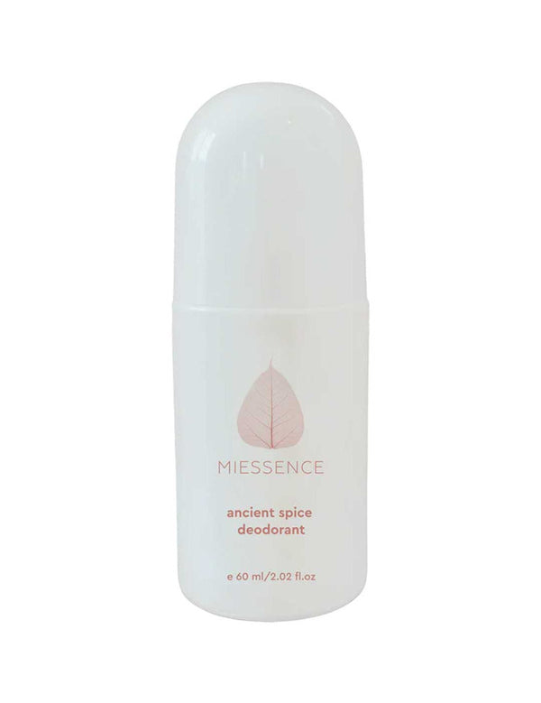 White Miessence Ancient Spice roll-on deodorant bottle with a tall rounded cap, a pale peach leaf emblem and small peach lettering on the front.