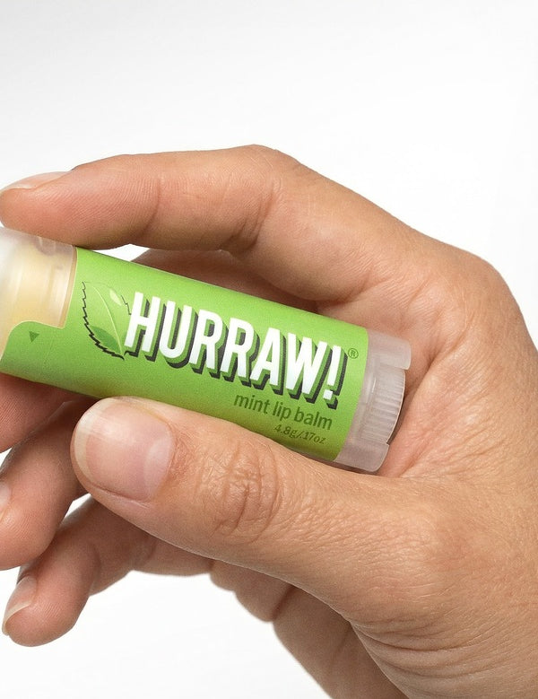 Hand holding Hurraw! Organic Lip Balm - Mint 4.8g