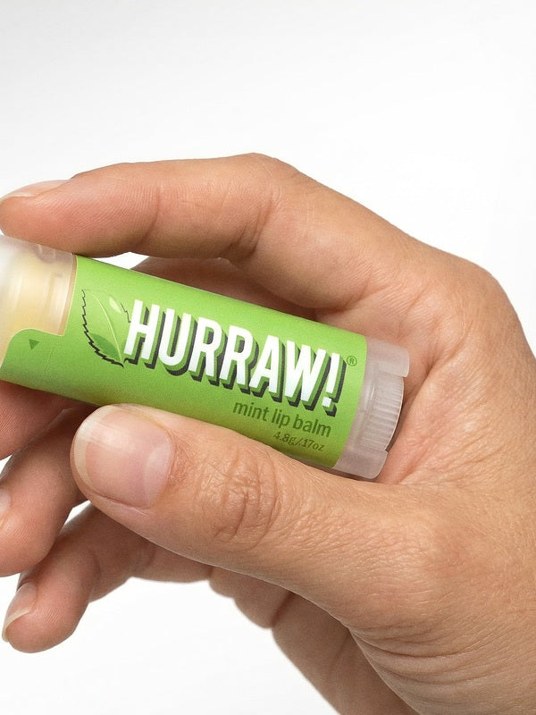 Hand holding Hurraw! Organic Lip Balm - Mint 4.8g