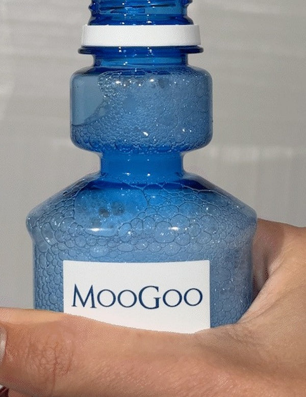 MooGoo Moothwash Spearmint bottle in hand