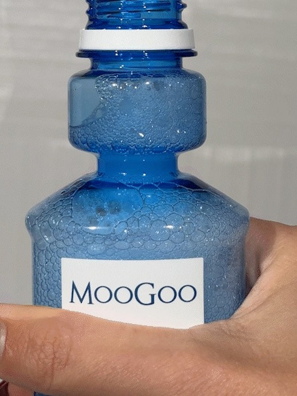 MooGoo Moothwash Spearmint bottle in hand