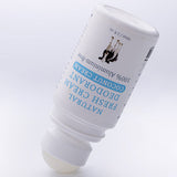 Uncapped white MooGoo Coconut Cream deodorant bottle tilted upside down with its exposed pale roller ball touching the surface.