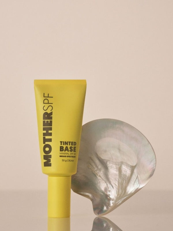MOTHER SPF Tinted Base styled with a pearl shell