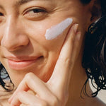 MOTHER SPF Face and Body sunscreen applied to the cheek